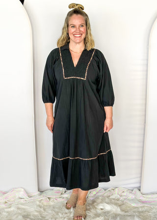 Black V-neck midi dress with leopard print detail on front and around bottom tier.