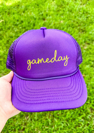 purple trucker hat with game day in gold cursive across the front - snap back