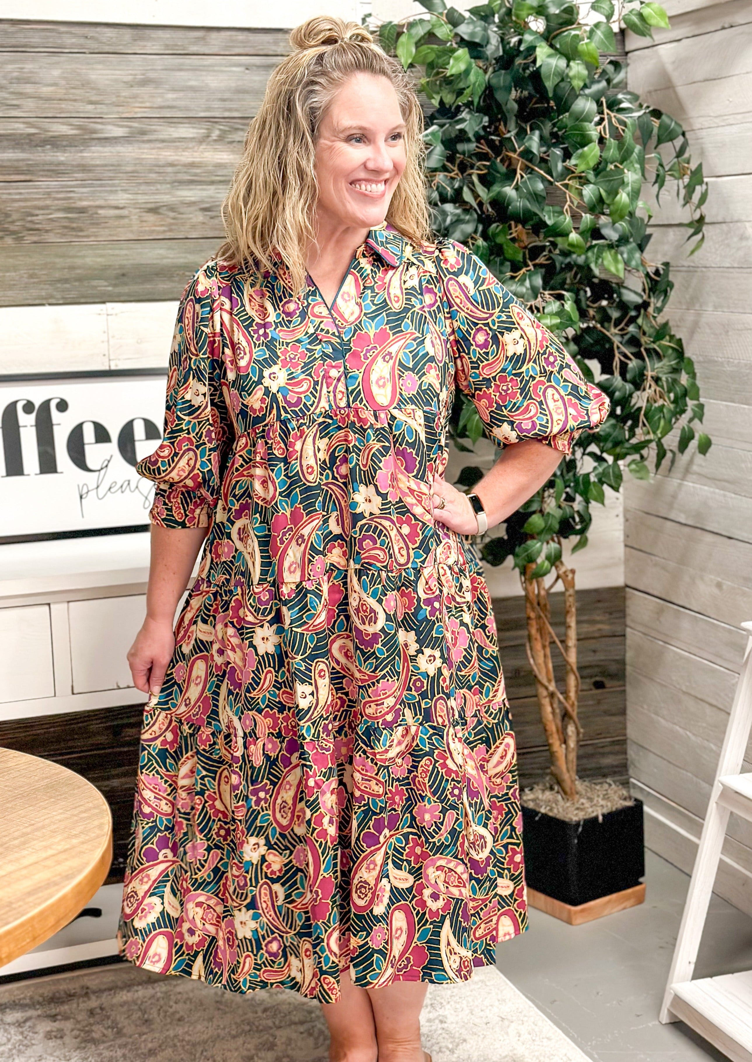 Paisley & Floral Tiered Midi Dress - dark teal/green background - elbow length sleeve with elastic banding - creams/pinks/blues/greans in the floral and paisley design - midi/maxi length - collared neck