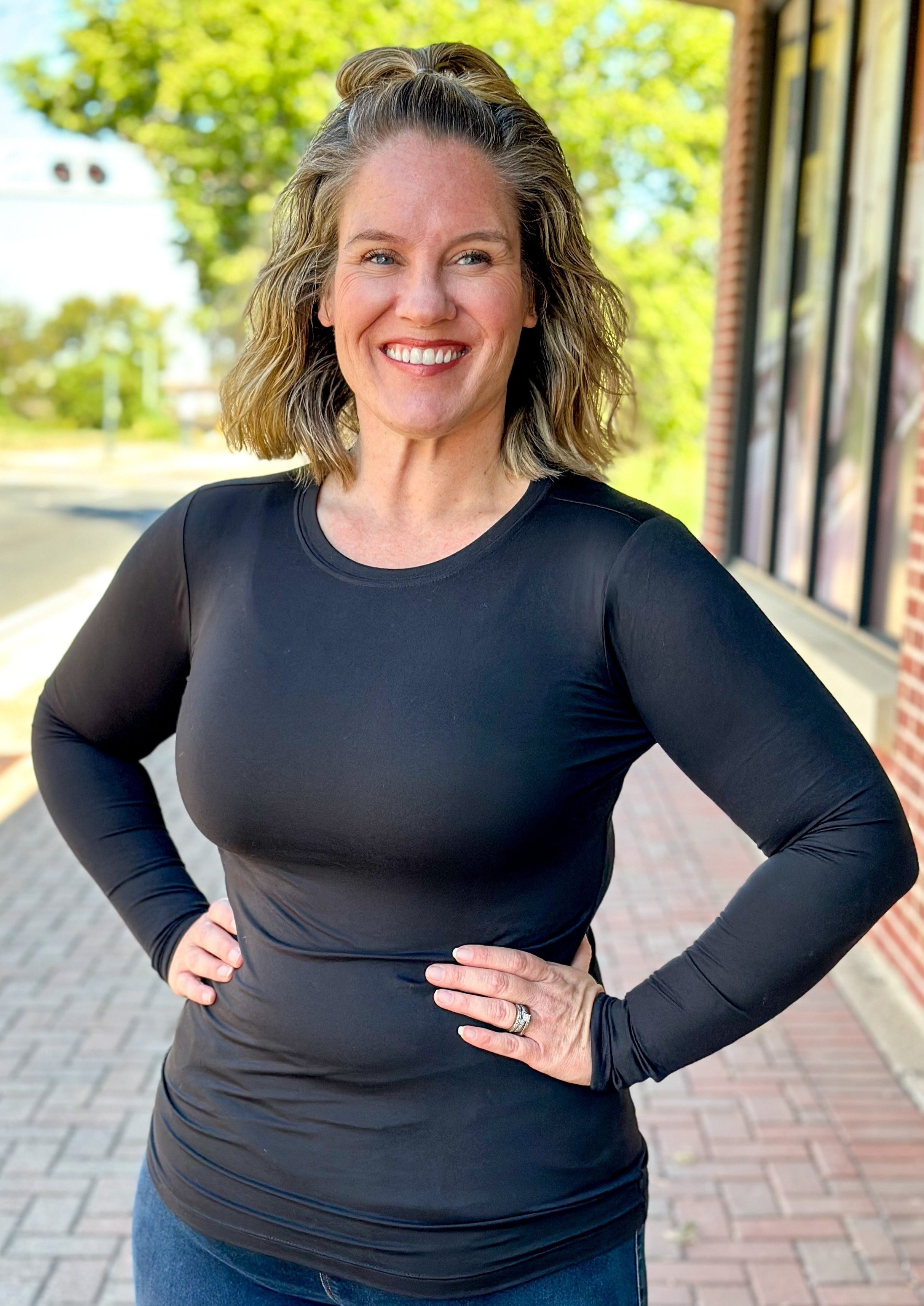 Fitted black long sleeve top, has a little stretch and full coverage.