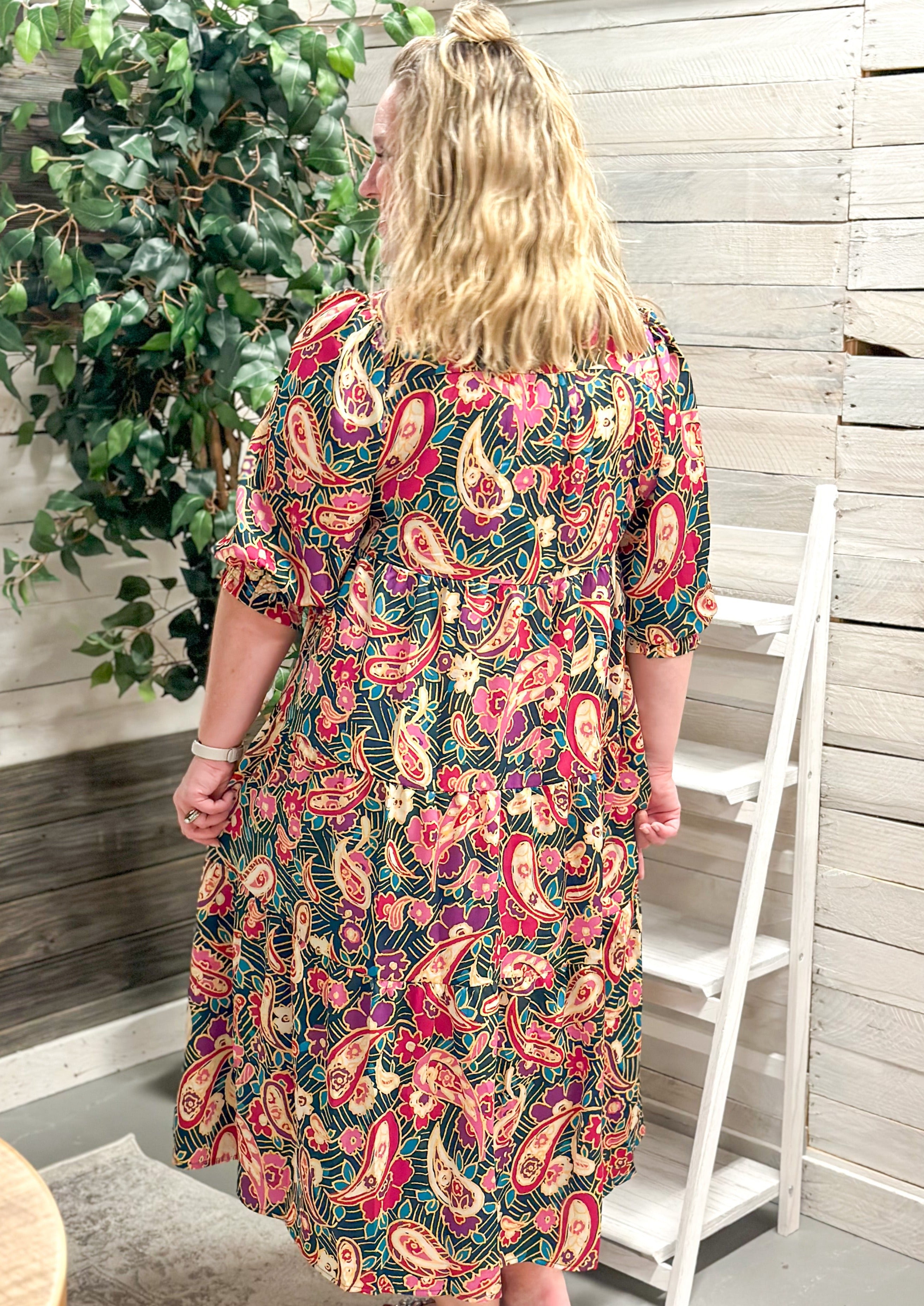 Paisley & Floral Tiered Midi Dress - dark teal/green background - elbow length sleeve with elastic banding - creams/pinks/blues/greans in the floral and paisley design - midi/maxi length - collared neck