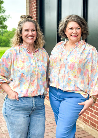 Pastel abstract print with building - v-neck with tie and ruffle - dolman 3/4 sleeve with elastic - lightweight