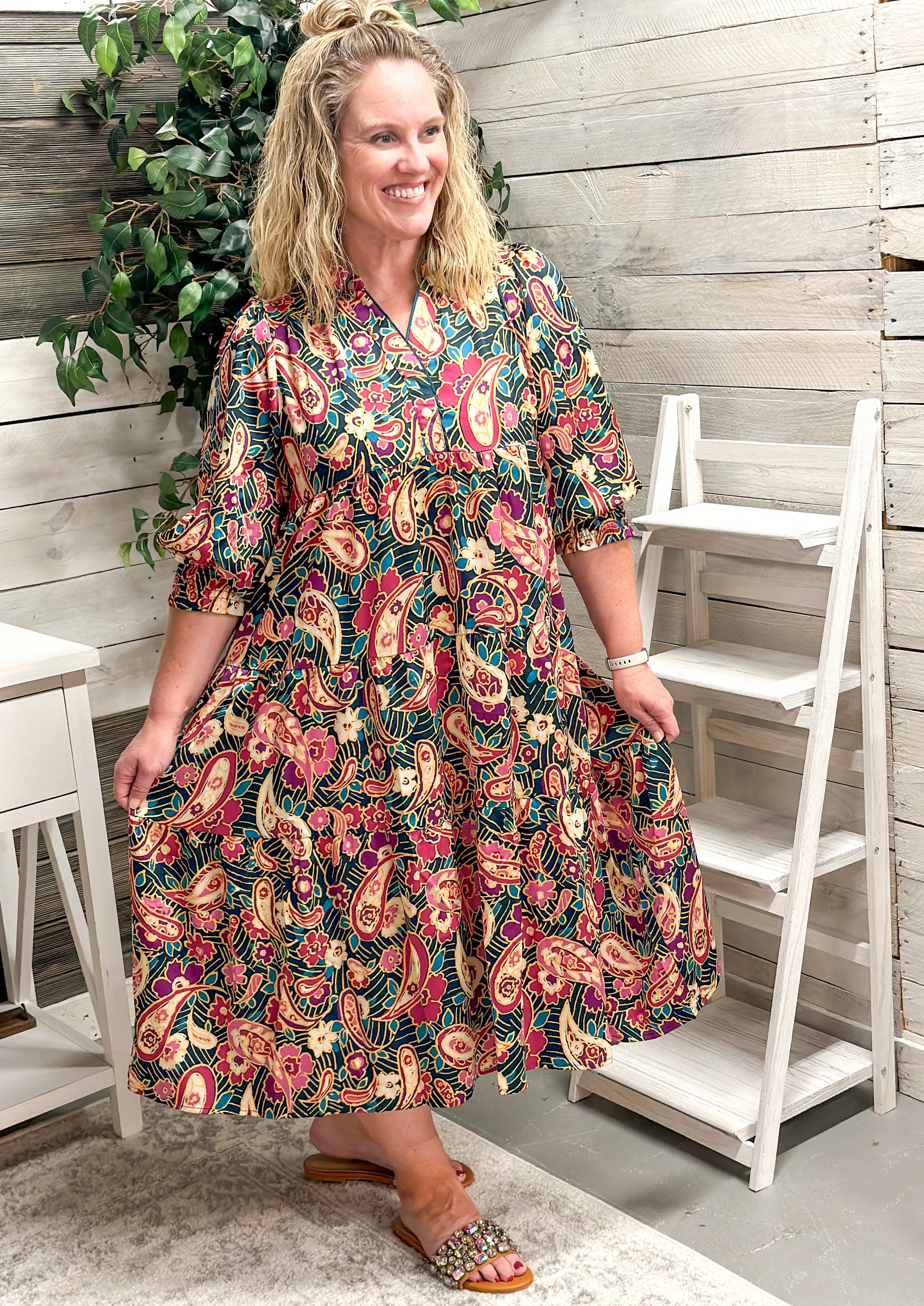 Paisley & Floral Tiered Midi Dress - dark teal/green background - elbow length sleeve with elastic banding - creams/pinks/blues/greans in the floral and paisley design - midi/maxi length - collared neck