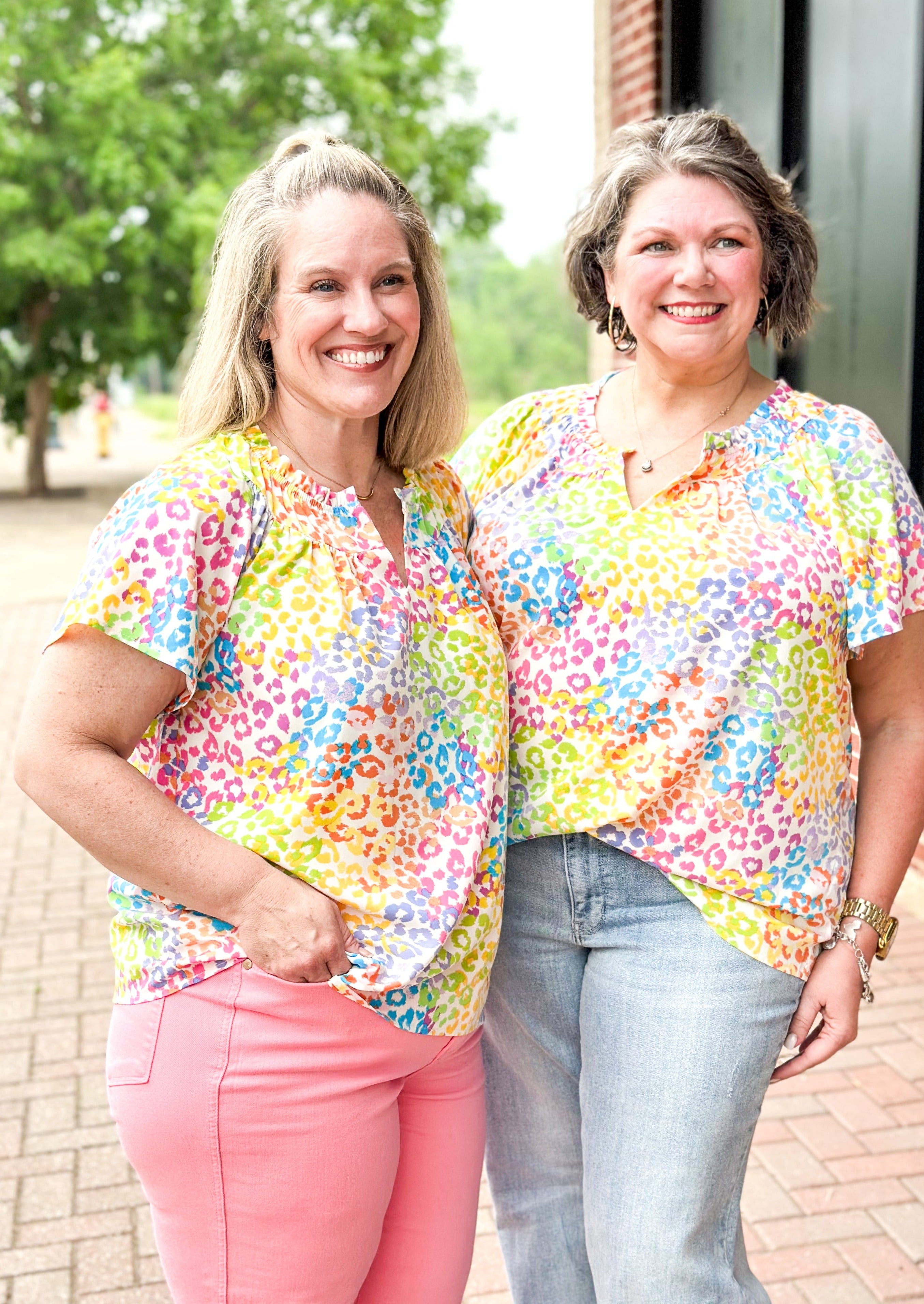 bright colored leopard print top - pinks, green, yellow, blue and orange leopard print on a white background - ruffle v-neck