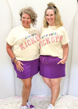 Purple skort with pockets and tie at waist.