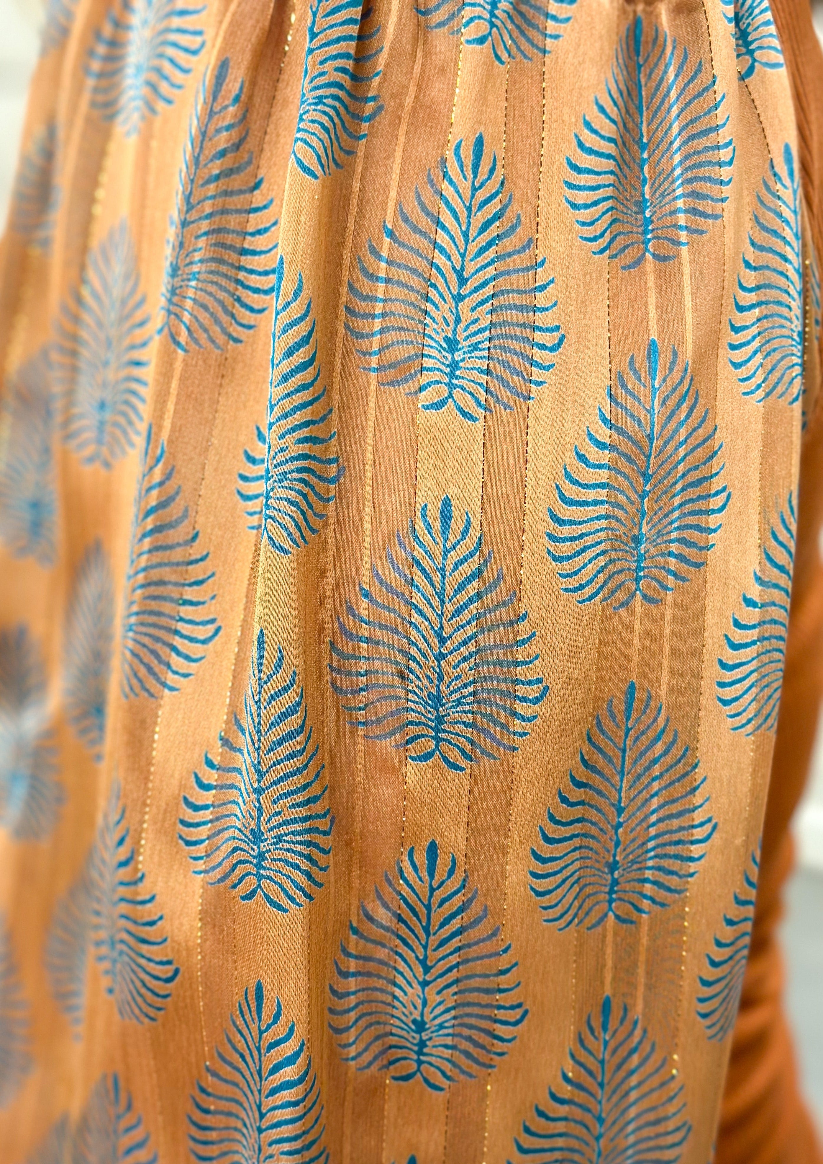Rust Colored Knit Ribbed Top with Blue Leaf Print Sleeve - Rust color sheer sleeve has gold thread and knit cuff - fitted top