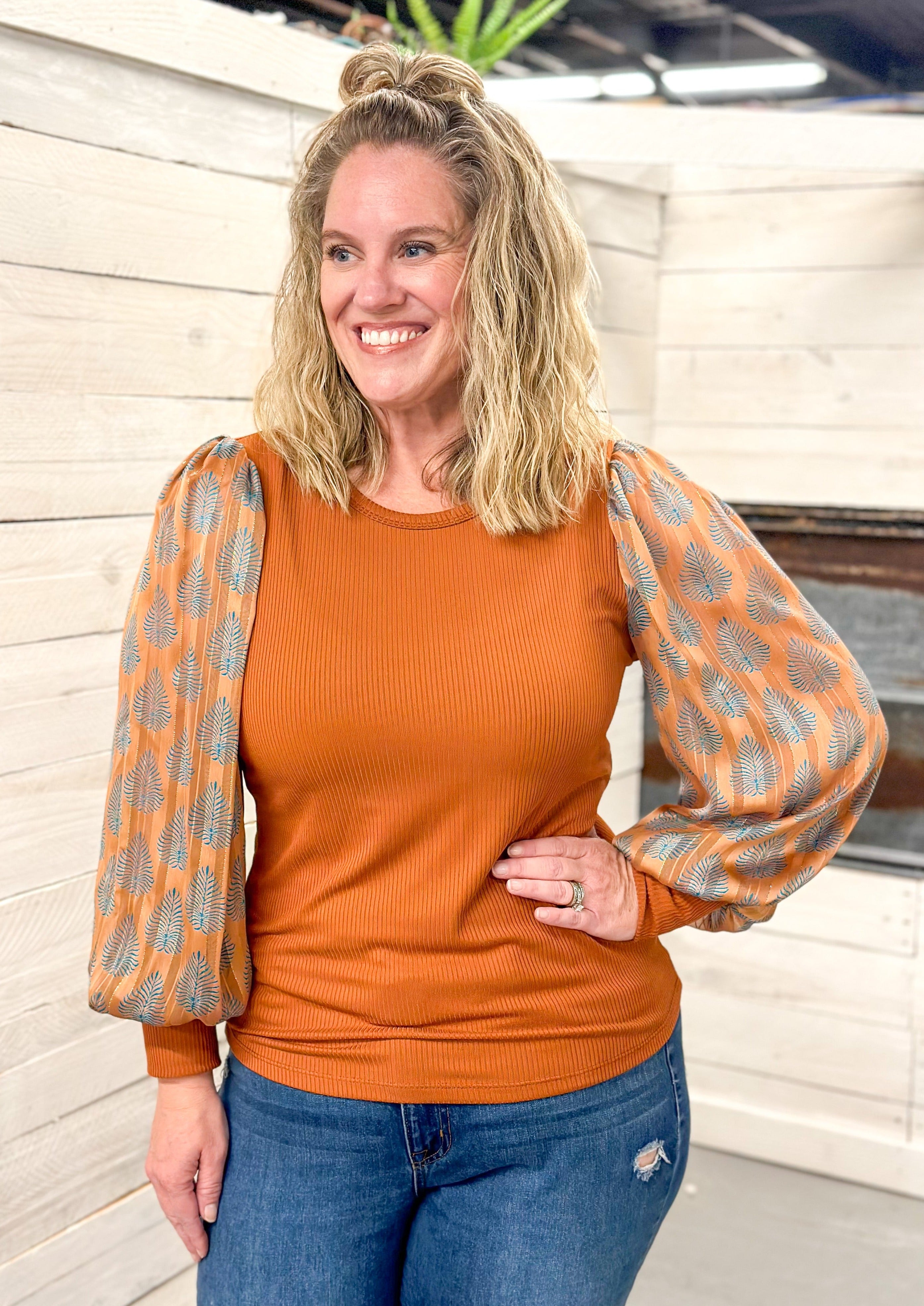 Rust Colored Knit Ribbed Top with Blue Leaf Print Sleeve - Rust color sheer sleeve has gold thread and knit cuff - fitted top