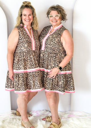 tiered leopard print dress with pink and white striped along collar and down the v-neck front and trimmed on the 2 tiers of the bottom portion of the dress - pockets
