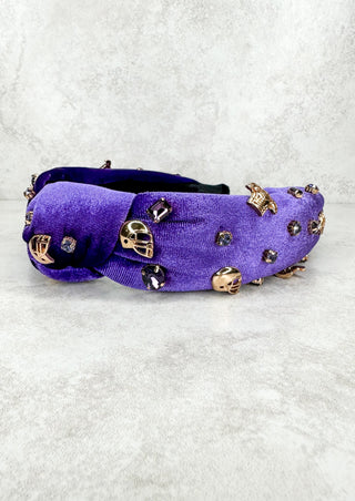 This velvet headband has gold helmets, jerseys and purple sparkles on it!