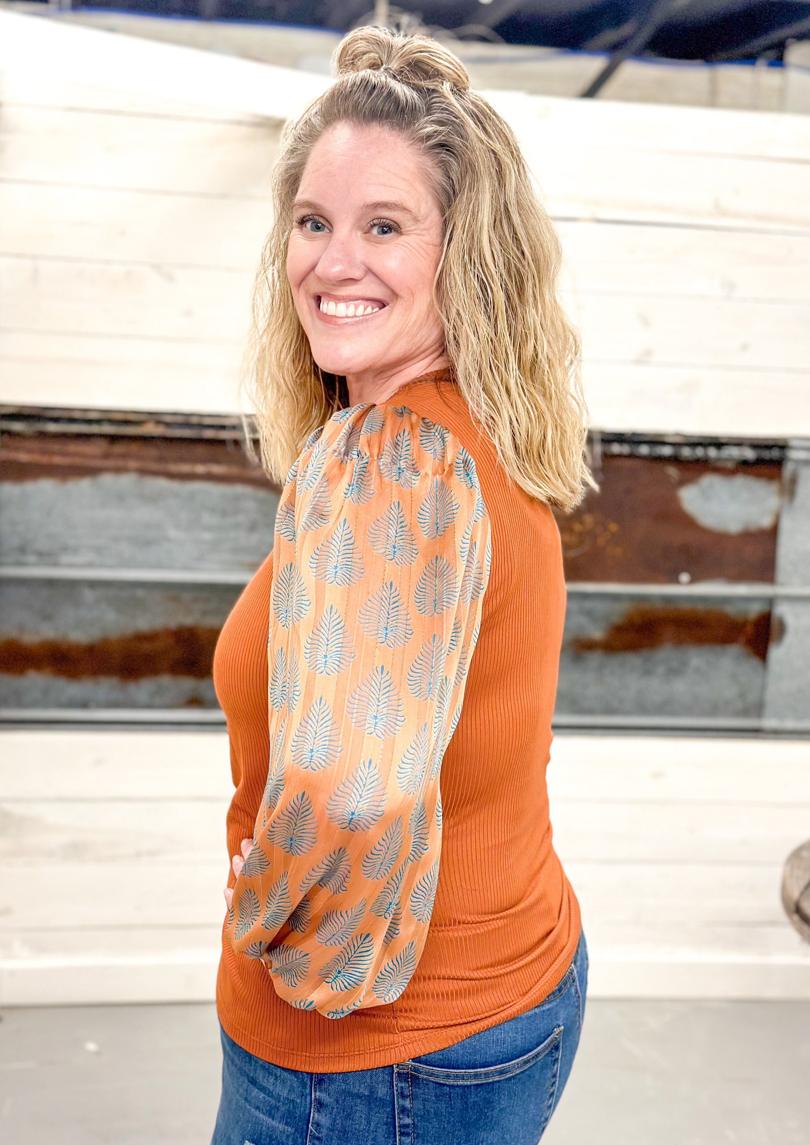 Rust Colored Knit Ribbed Top with Blue Leaf Print Sleeve - Rust color sheer sleeve has gold thread and knit cuff - fitted top