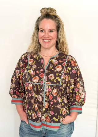 Fall floral Babydoll top with 3/4 puff sleeve, orange and blue strip detail on banding of hem and sleeve. blue ribbon detail on the front and tie at the collar.