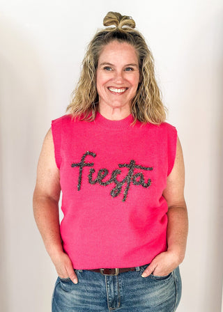 sleeveless sweater hot pink with "fiesta" in cursive tinsel across the front