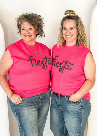 sleeveless sweater hot pink with "fiesta" in cursive tinsel across the front