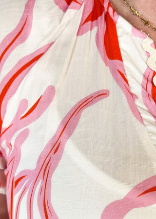 short sleeve dress with v-neck, tiered skirt and elastic waist - ric rack detail around neckline and sleeve - cream background with pink and red floral print - pockets