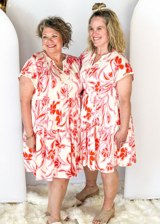 short sleeve dress with v-neck, tiered skirt and elastic waist - ric rack detail around neckline and sleeve - cream background with pink and red floral print - pockets
