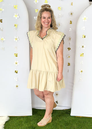 Short sleeve tiered ruffle dress with pockets. Double scallop detail in contrasting color on sleeves and  v-neck.