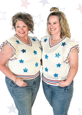 ruffle short sleeve net like cream sweater - need to wear something underneath - blue sequin star patches and red and blue trim around v-neck, bottom banding and ruffle on sleeve