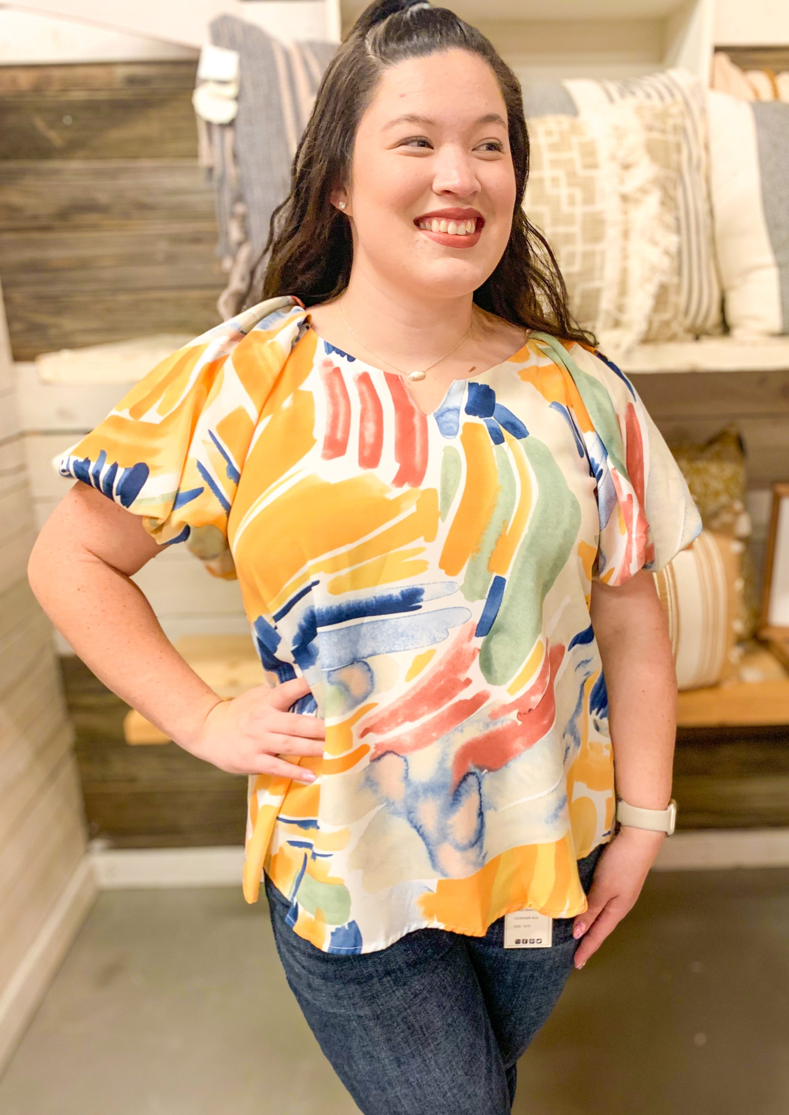 mustard, pink and blue abstract over cream top with puff sleeve