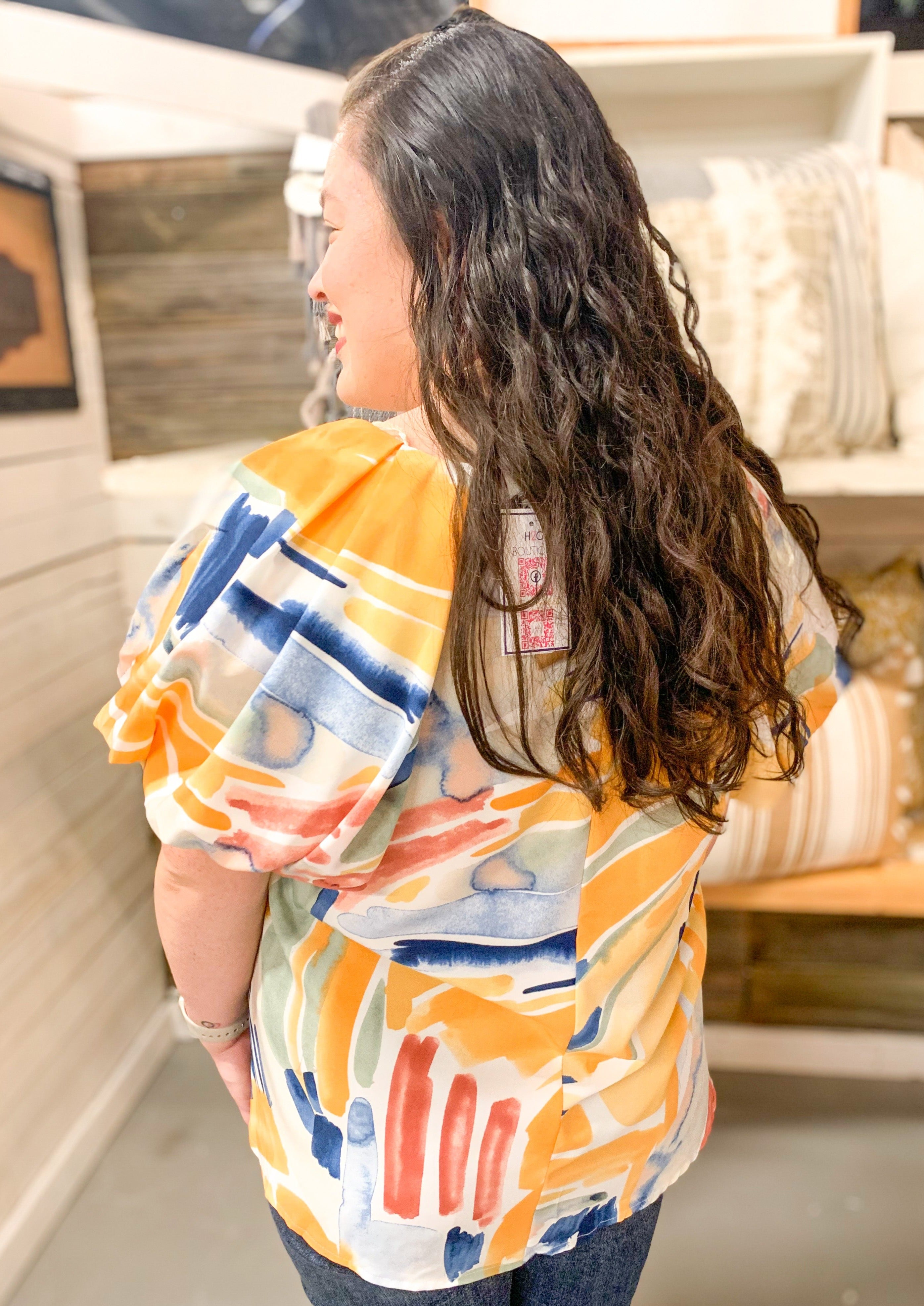 mustard, pink and blue abstract over cream top with puff sleeve