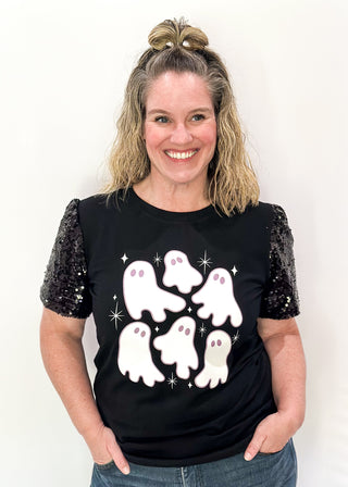 Black short sleeve top with sequin sleeves. Multiple white ghosts on the front