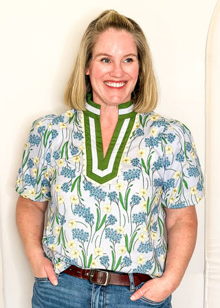 Spring floral top with short sleeves, easy silhouette, and colorful blue and green pattern.