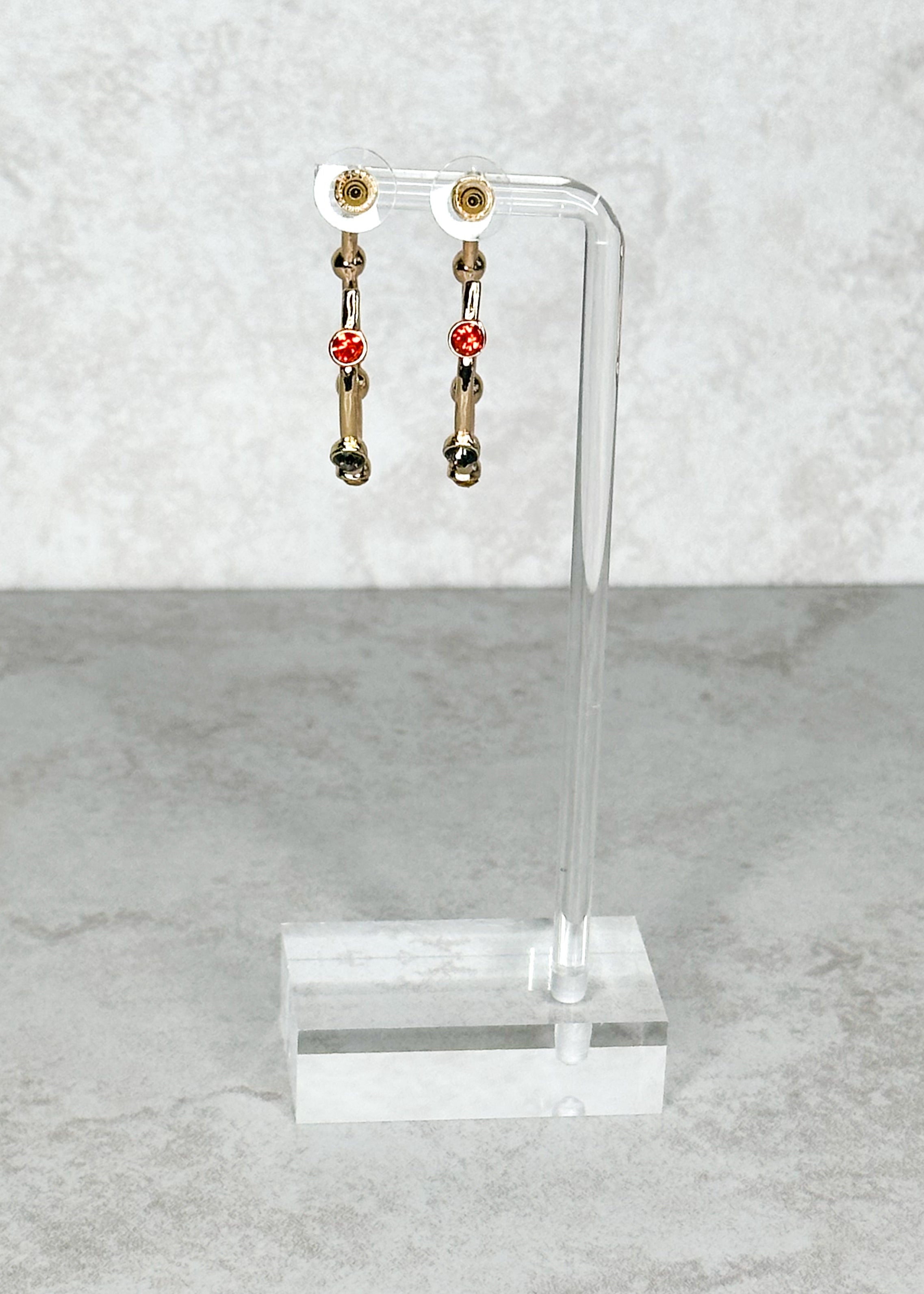 Gold with multi-colored jewels, open hoop, post back earrings.