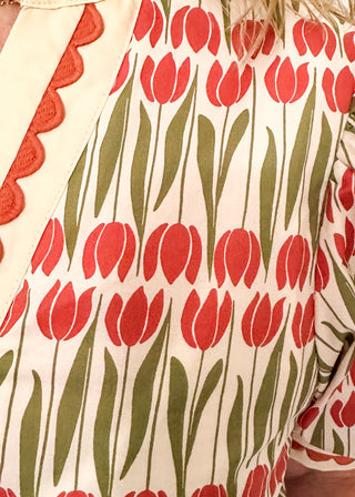 Large puff sleeve top with terracotta tulips and green leaves.  Contrast is ecru with terracotta scallop detail-short sleeve and v-neck.