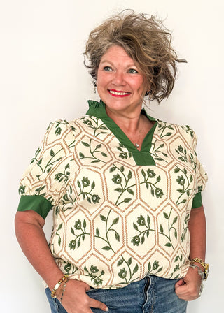Neutral blouse featuring green florals with geometric hexagon pattern