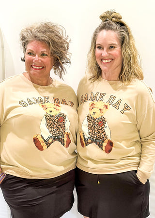 Tan long sleeve pullover with "GAME DAY" in arched bold lettering above Benny the Bear in his leopard letterman jacket.  