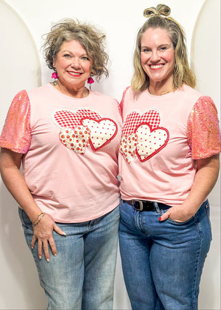 Sequin short sleeve top with 3 heart appliques.