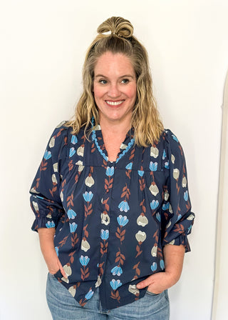 navy 3/4 length top with light blue and cream flowers and brown stems - light blue scalloped trim detail around v-neck