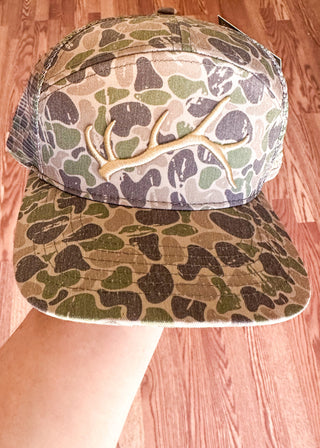 Men's camouflage Fieldstone hat with antler logo.