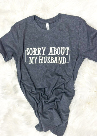 Charcoal t-shirt with 'Sorry About My Husband' text on a white surface