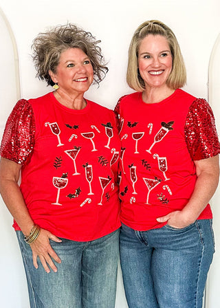 Two women modeling a short sleeve red sequin sleeve top with sequin drinks on the front. 