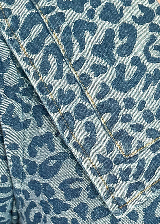 Denim and leopard print jacquard dress with short sleeves and pockets.  Sailor Collar with tie at the v-neck.  Buttons up the front of the dress and hits above the knee. 