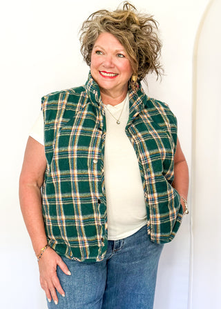 Green plaid puffer vest with snap front and side pockets.