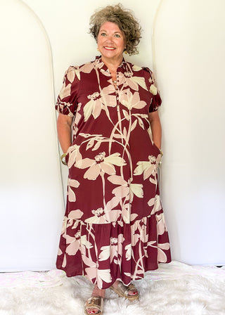 woman wearing tiered midi dress in Burgundy abstract floral print.