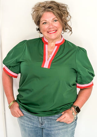 Green Puff Sleeve top with short sleeves and v-neck.  Contrast binding in pink and orange on sleeve and collar. 