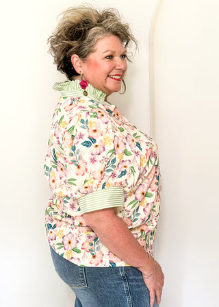 Women’s floral blouse with button front detail and green striped contrast accents