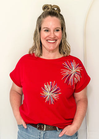 Red short sleeve top with 2 sequin firework bursts.