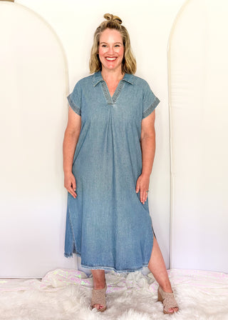 Woman wearing a blue dress standing against a white background