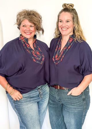 Navy dolman sleeve top with plaid contrast trim 