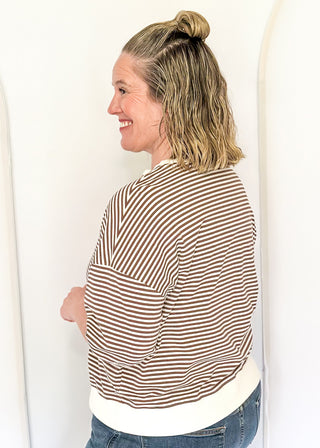 Striped knit dolman top with crew neckline and ribbed trim in brown.