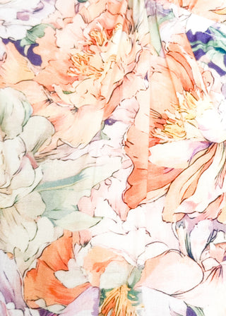 Close up of floral maxi dress with short puff sleeves, elastic waist, and flowy maxi skirt