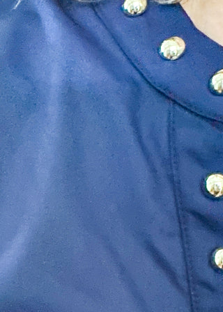 Navy v-neck blouse with puff sleeve.  Silver stud detail along hem, collar and down the front. 