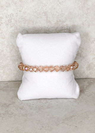 Rose beaded bracelet displayed on a stand 