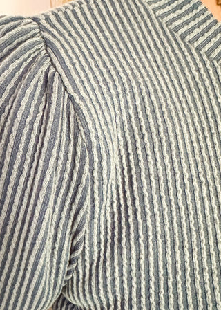 long sleeve ribbed top with cuff sleeve and small puff detail in shoulder. crew neck. 