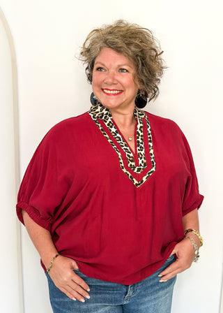 dolman short sleeve top in garnet color with double leopard stripe v-neck