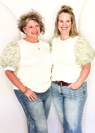 White ribbed knit top with pastel watercolor puff short sleeves. 