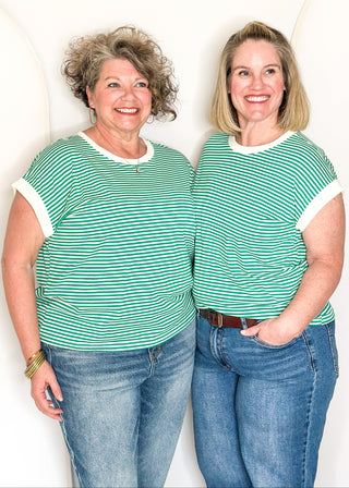 Green and white striped short sleeve top with white banding on sleeve and collar. 